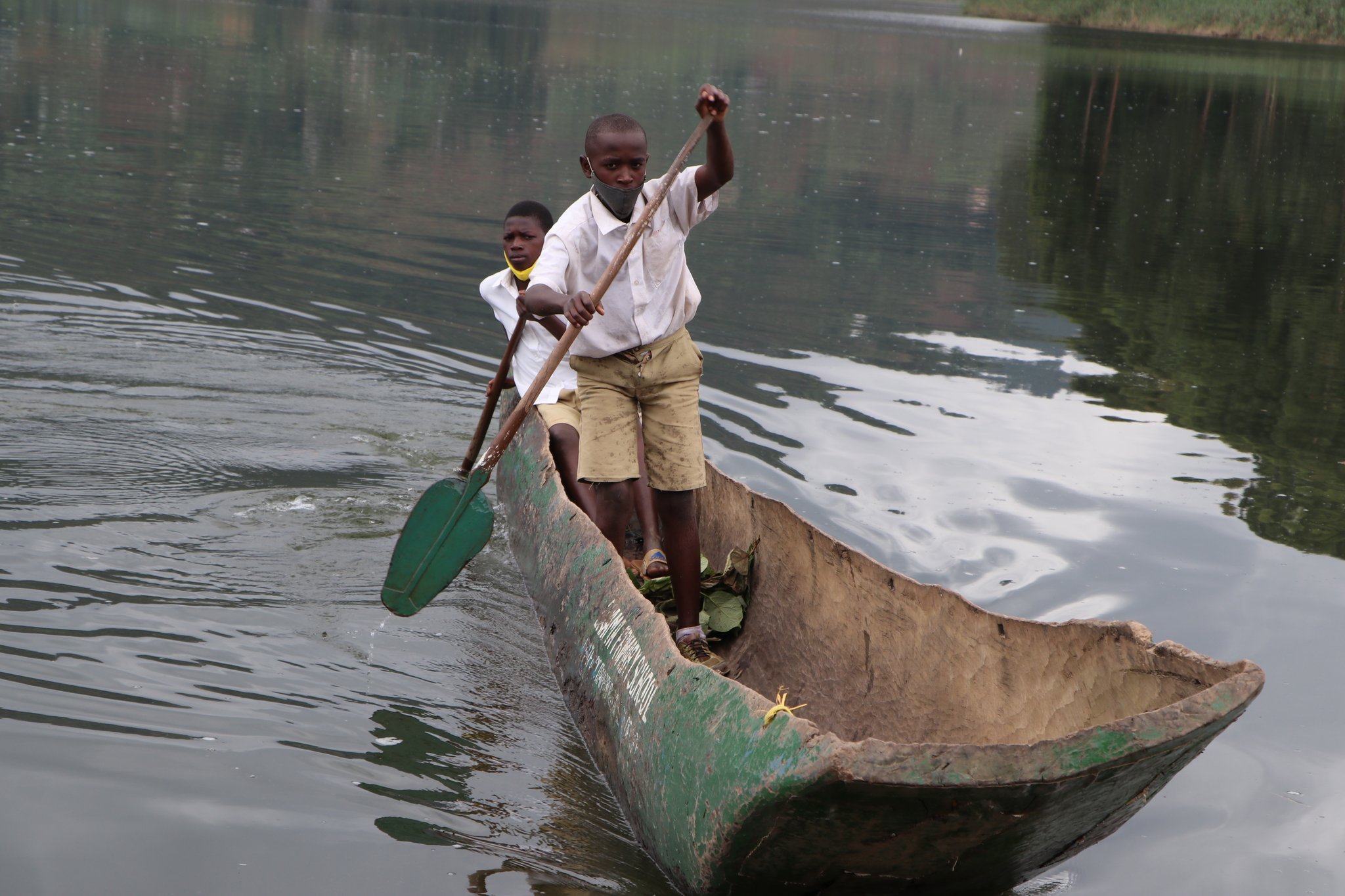 Children canoeing to school on Lake Bunyonyi in Uganda. Photo by Uganda Red Cross Society