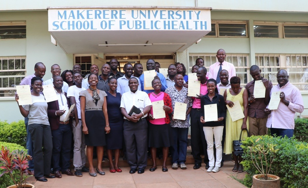 The Guest of Honour, Prof Nazarius Mbona Tumwesigye (white shirt, front row), the Head of Department of Epidemiology and Biostatistics, took a group photo with the graduands outside the MakSPH Building in Mulago. Dr. Esther Buregyeya (fourth left, front row), the Head of Department of Disease Control and Environmental Health, under which the WASH programme falls
