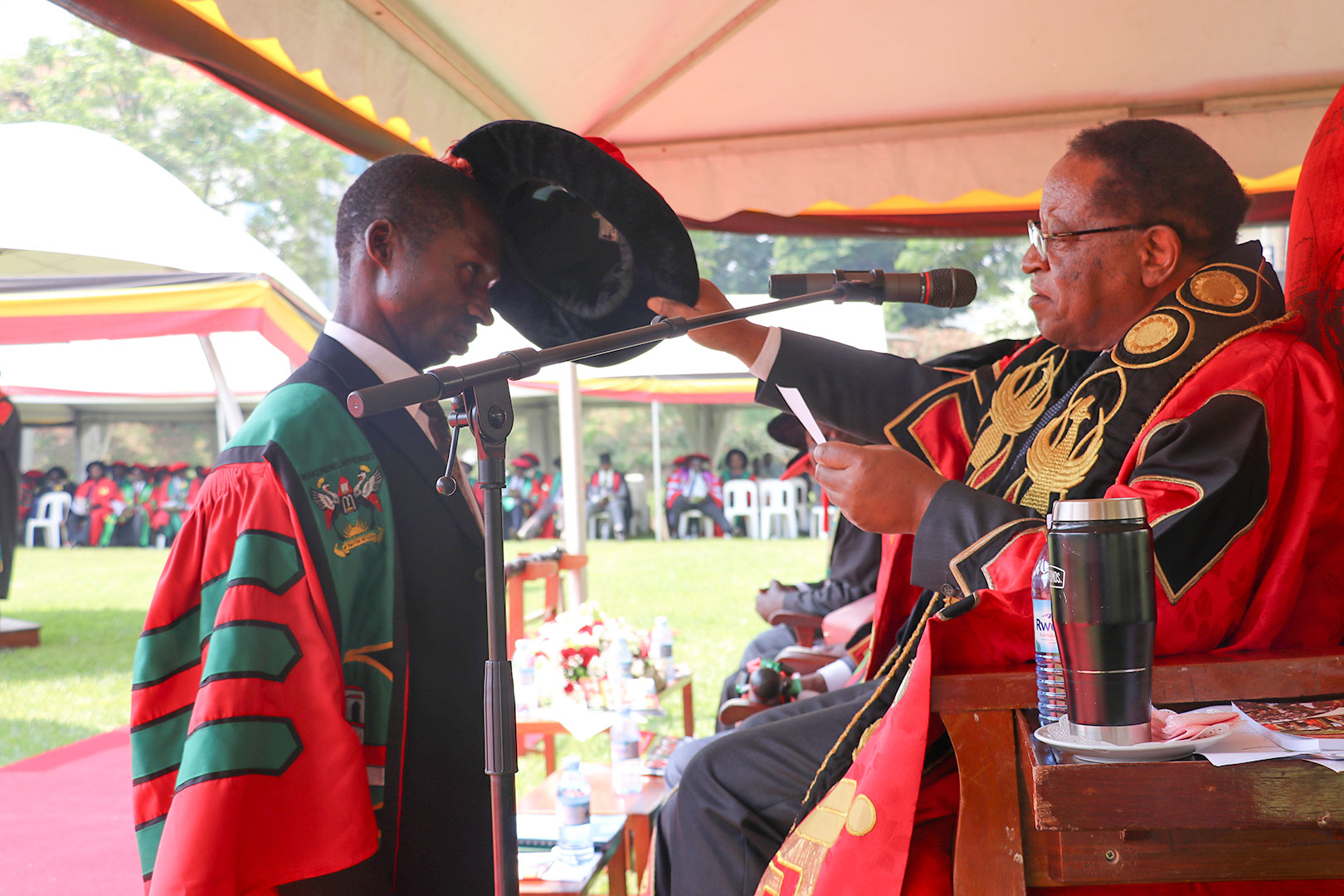 The Chancellor of Makerere University, Prof Ezra Suruma confers a PhD upon Dr Godfrey Bwire