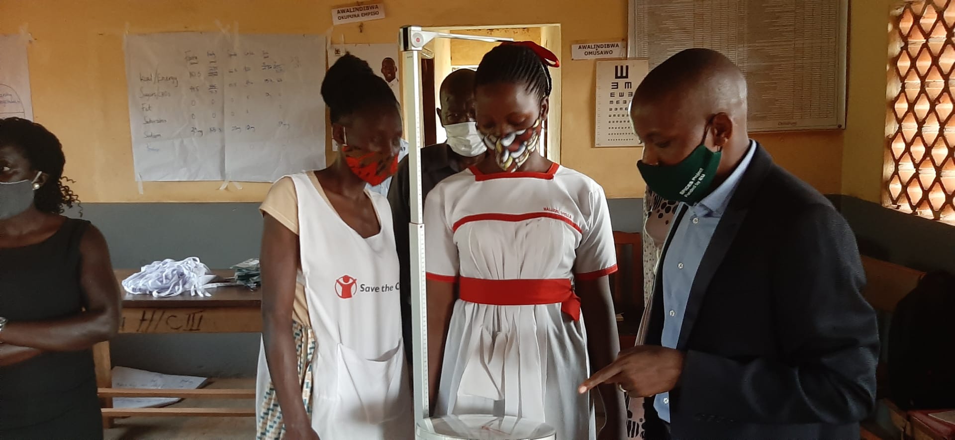 Dr. Geofrey Musinguzi, the SPICES director demonstrates to trainees at Kasawo HCIII on how to operate a measuring rod.