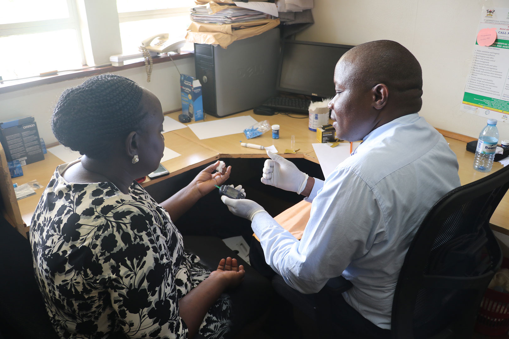 Dr.Aggrey Mukose conducting a screening test on a participant during the screening exercise