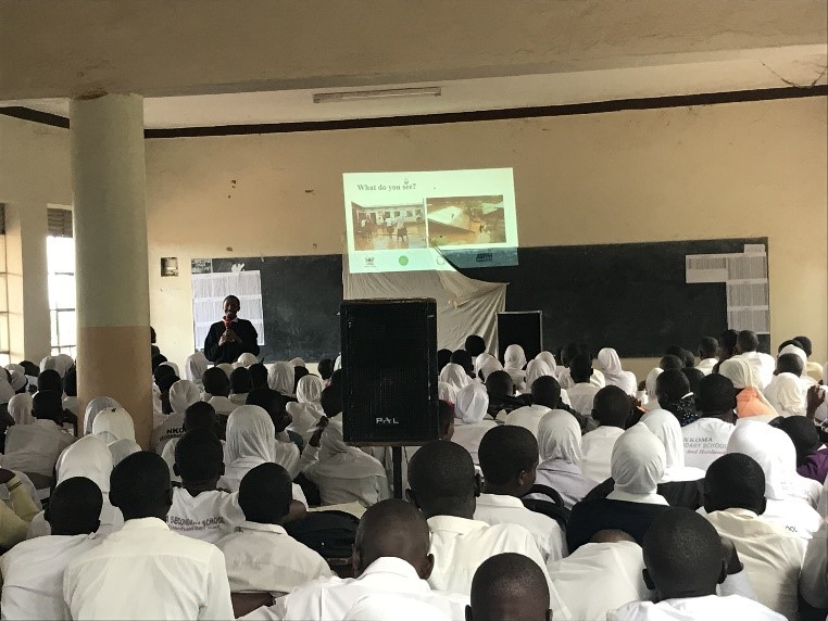 Filimin Niyongabo, a postgraduate student of Master of Environmental and Occupational Health (MEOH) at MaKSPH and the TIPH global ambassador speaking to students during an environmental health education session on floods and landslides at Nkoma Secondary School.