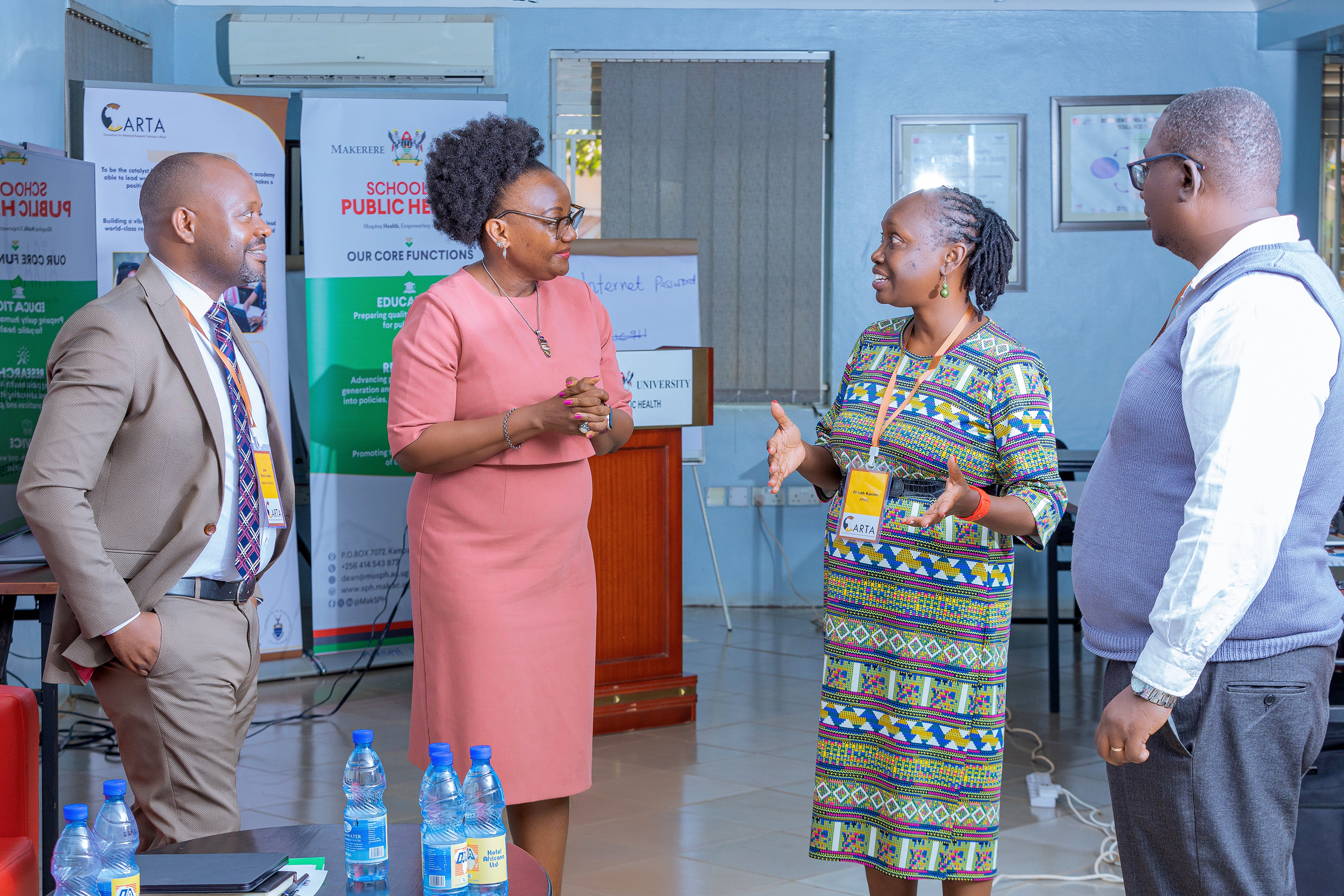 At the center, MakSPH Dean Prof. Rhoda Wanyenze speaks with Dr. Flora Karimi, CARTA Program Manager for Institutionalization, during the launch of the 11th Cohort of CARTA doctoral fellowship at Makerere University on March 3, 2025. To the left is CARTA Board Member Dr. JB Isunju, alongside Facilitator and CARTA Alumnus Dr. Andrew Tamale.