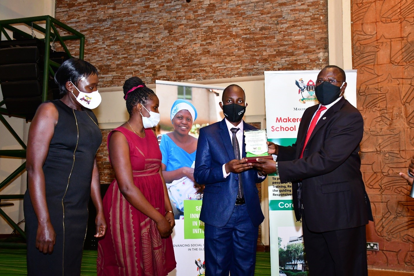 Mr. Lubega Martin, the author of a 48-paged, A4 portable short My Pregnancy handbook receives an award from Dr. Maxwell Otim Onapa, the Director of Science, Research and Innovation at Ministry of Science, Technology and Innovation. 