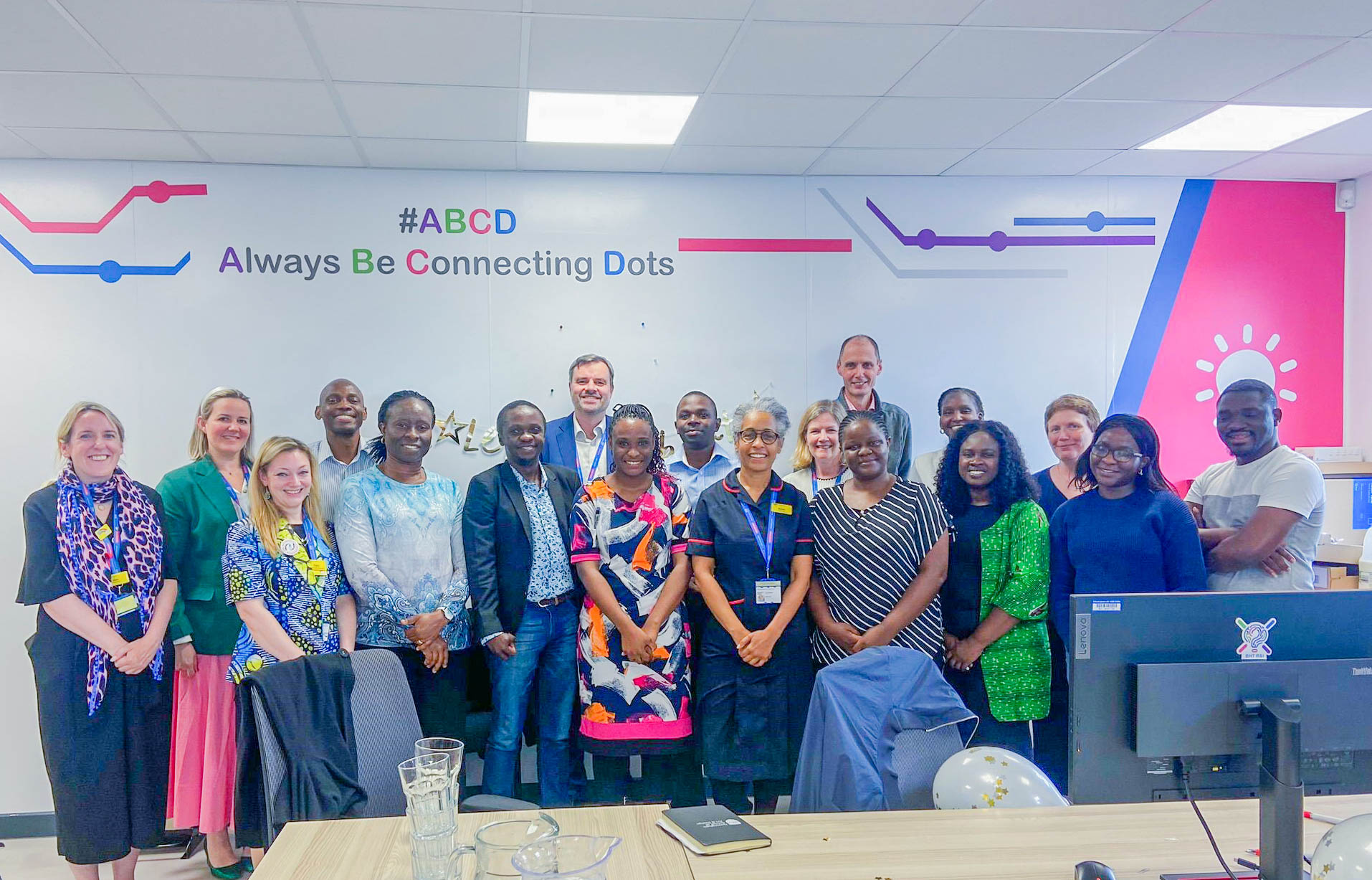 Group photo with the Buckinghamshire NHS Health Care Trust hospital executive: (left to right) Kate Russell-Hobbs -HIV and Sexual Health Pharmacist; Claire Brandish - lead, Anti-infectives pharmacist; Charmaine Hope (in green coat) - Chief Estates and Facilities Officer; Duncan Dewhurst (in blue coat) - Chief Digital Information Officer; Karen Bonner (in blue dress) - Chief Nurse and DIPC Bridget O’Kelly (in white blouse) - Chief People Officer; and Andrew McClaren - Medical Director.