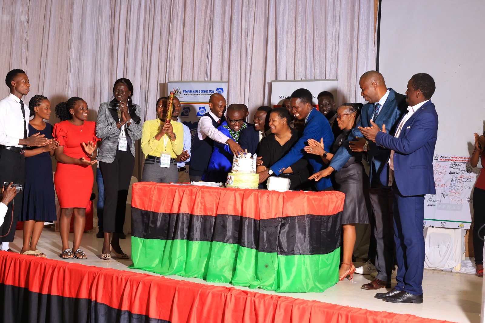 MUEHSA leadership and invited celebrate the 18th annual MUEHSA scientific conference following a two-day conference at the Yusuf Lule Central Teaching Facility with cake cutting.