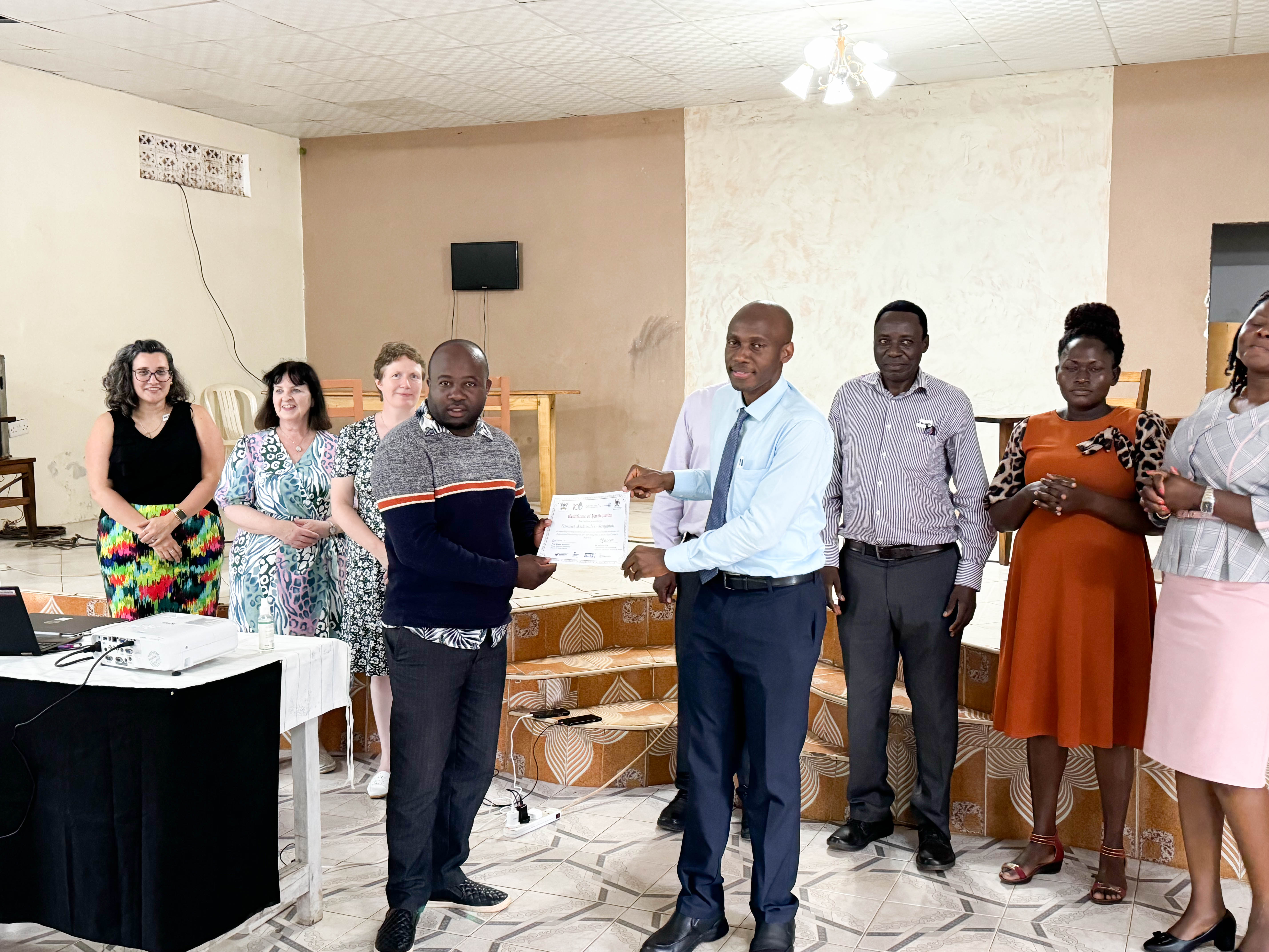 Certificate presentation to participants in Butambala district.