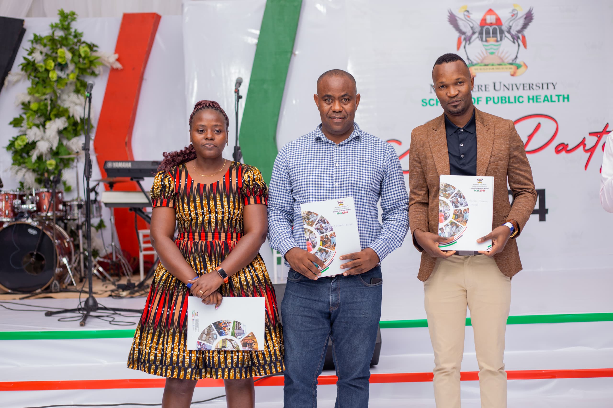 L-R: Irene Wanyana, Dr. Edward Buzigi and Michael Toskinz Wagaba, presenting their awards at the staff end of year party on December 13, 2024