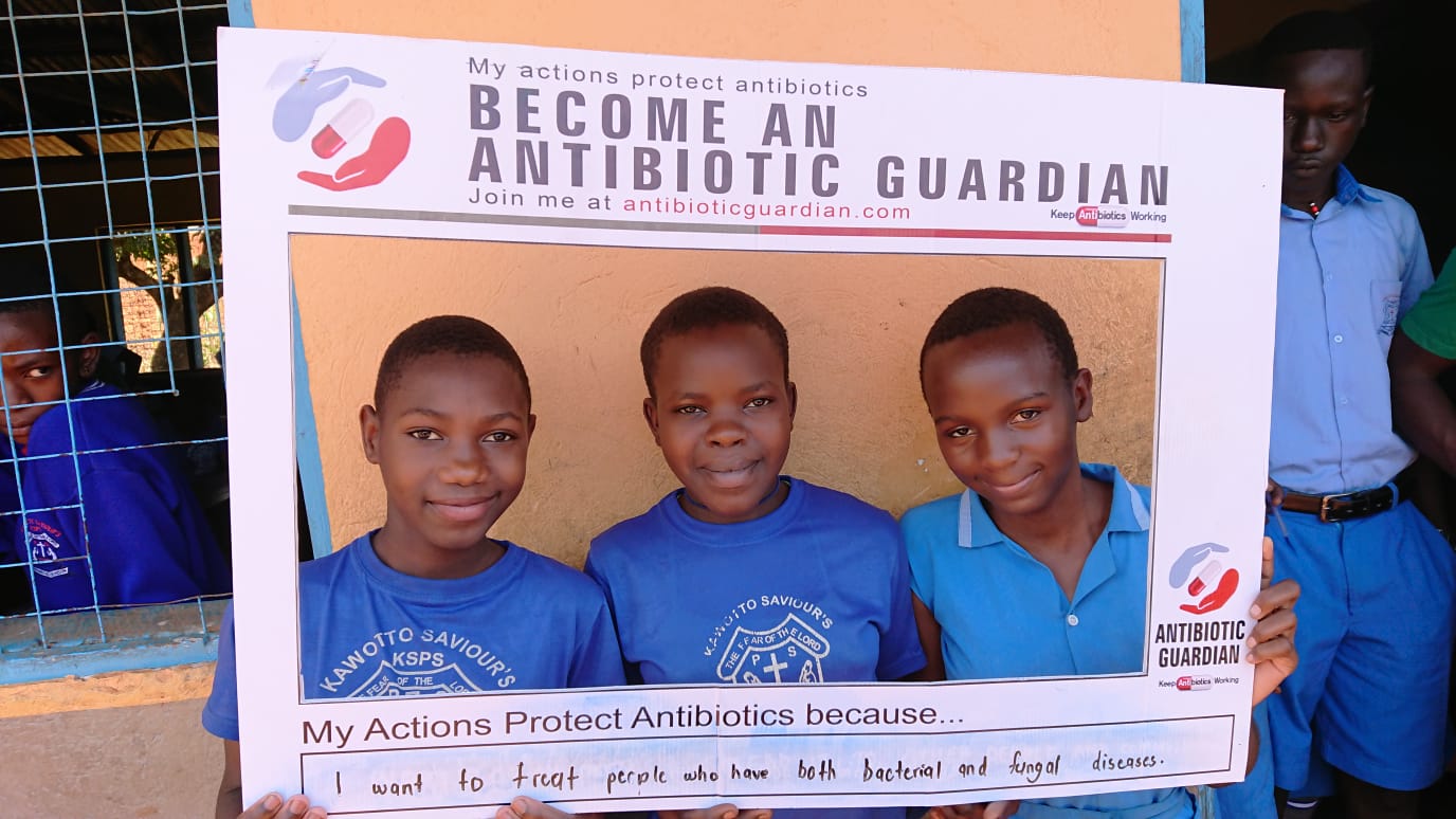 Pupils at Kawotto Saviours Primary School in Kajjansi show their commitment to become antibiotic guardians after a health education session by the project team.