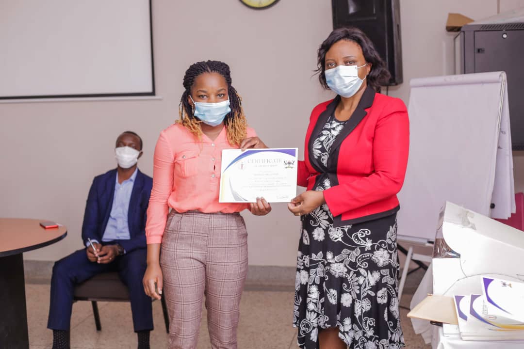 Nabbanja receives a leadership certificate from Dr. Damalie Nakanjako, Professor of Medicine, and Principal of the College of Health Sciences
