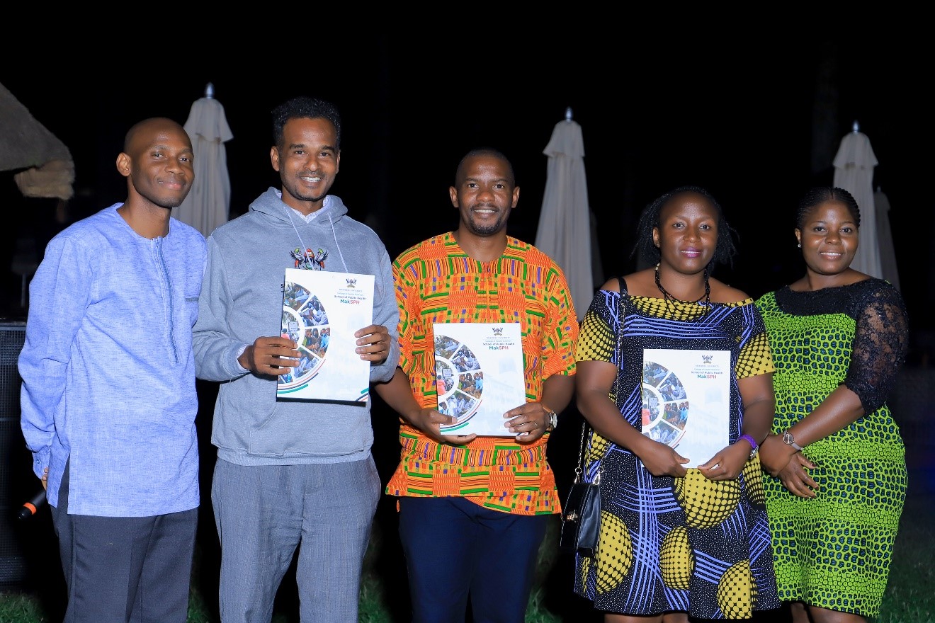 Dr. David Musoke (left – Chair of the Grants and Research Capacity Building Committee) and Ms. Stella Kakeeto (right – Secretary of the Grants and Research Capacity Building Committee) with the 3 grant recipients (left to right: Mr. Abdullah Ali Halage, Dr. John Ssenkusu, and Ms. Juliana Namutundu).