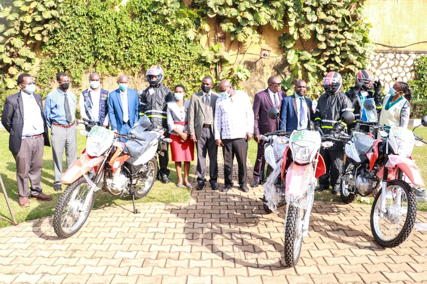A group photo of Wakiso District leaders, the project team, health practitioners and VHTs during the handover ceremony of the 3 motorcycles.