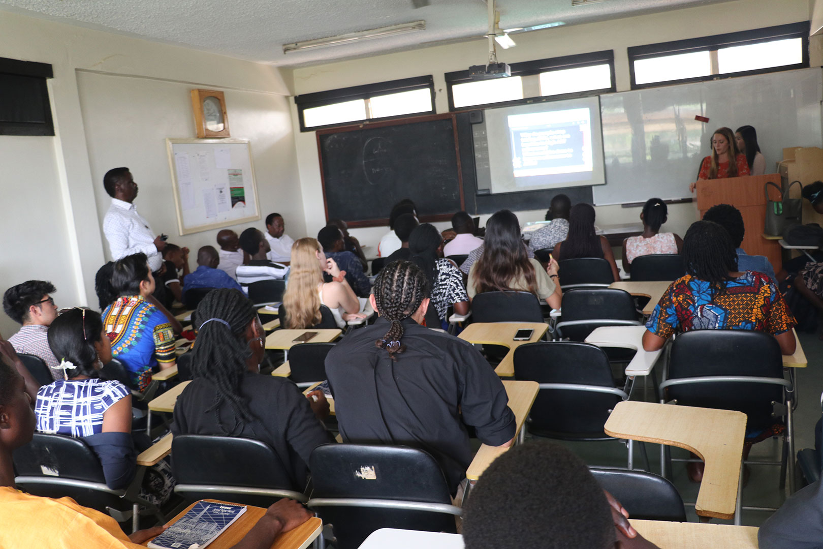 Makerere University and John Hopkins  students making a joint presentation at the seminar.