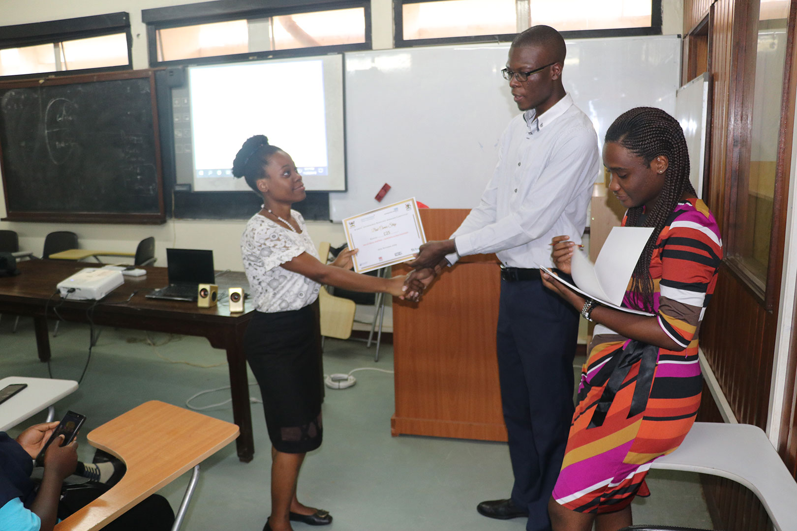 One of the students receiving a certificate for participating in the Antimicrobial Awareness Competition
