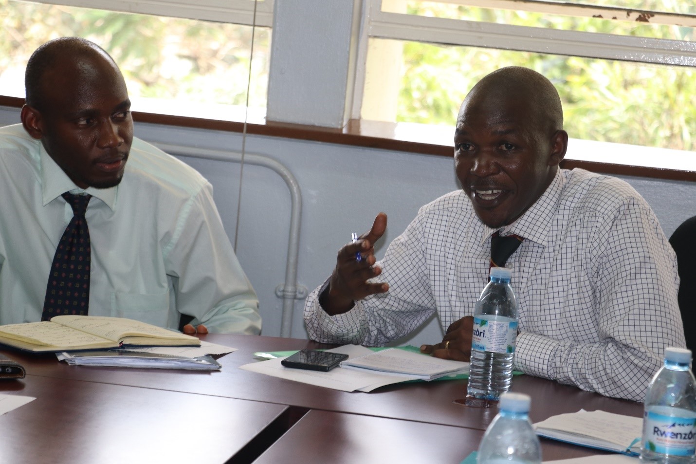 Dr. Freddy Kitutu (right) who will be leading the pharmacy side of the collaboration, speaking in the meeting. Left is Dr. David Musoke, the Project Lead from the Ugandan side.