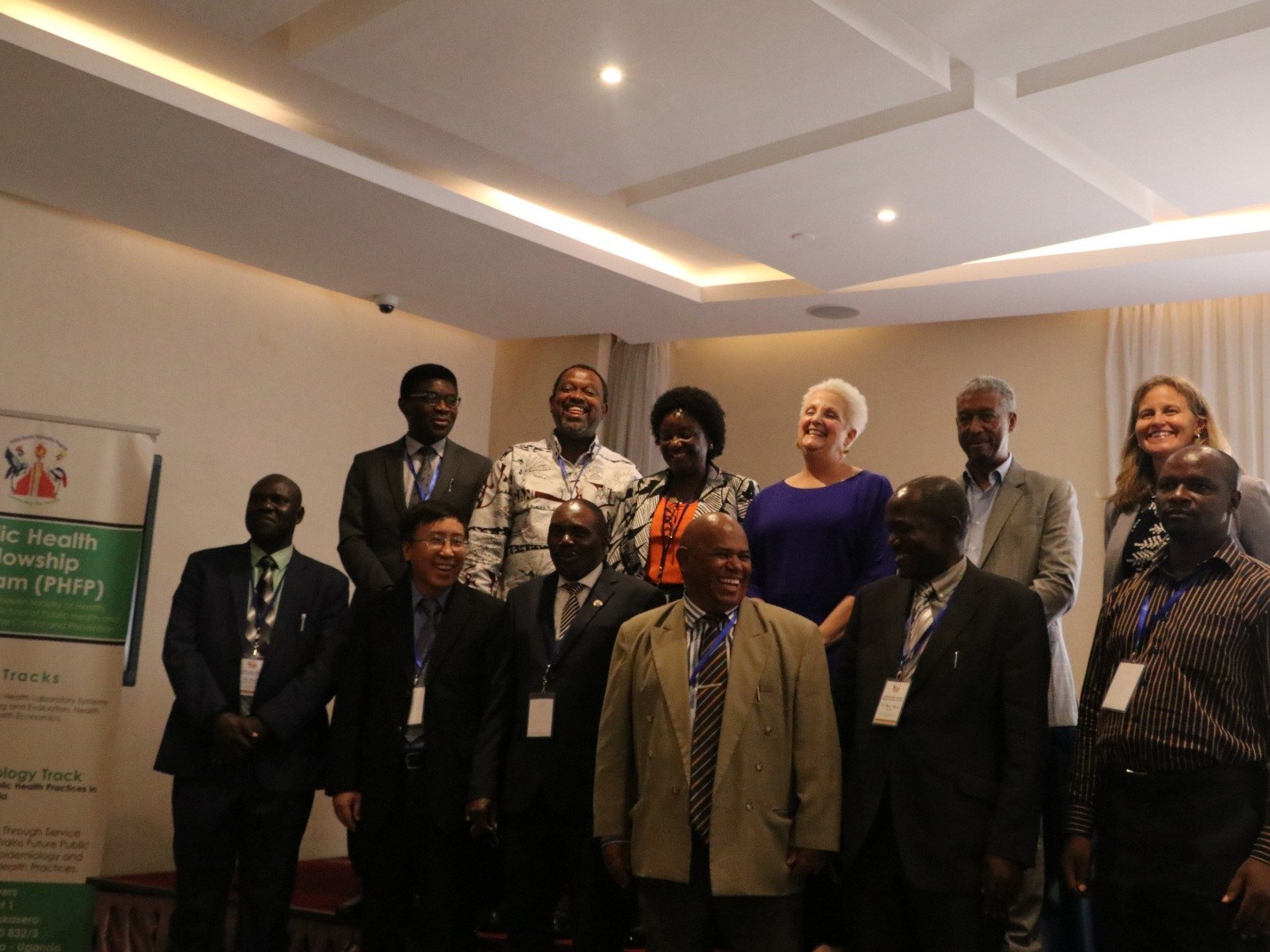 Dr. Patrick Tusiime, second left top row, the Commissioner Health Services and the Program Co-Director of the Public Health Fellowship Program. He was posing with the dignitaries at the graduation and other mentors of the Fellows that attended the function.