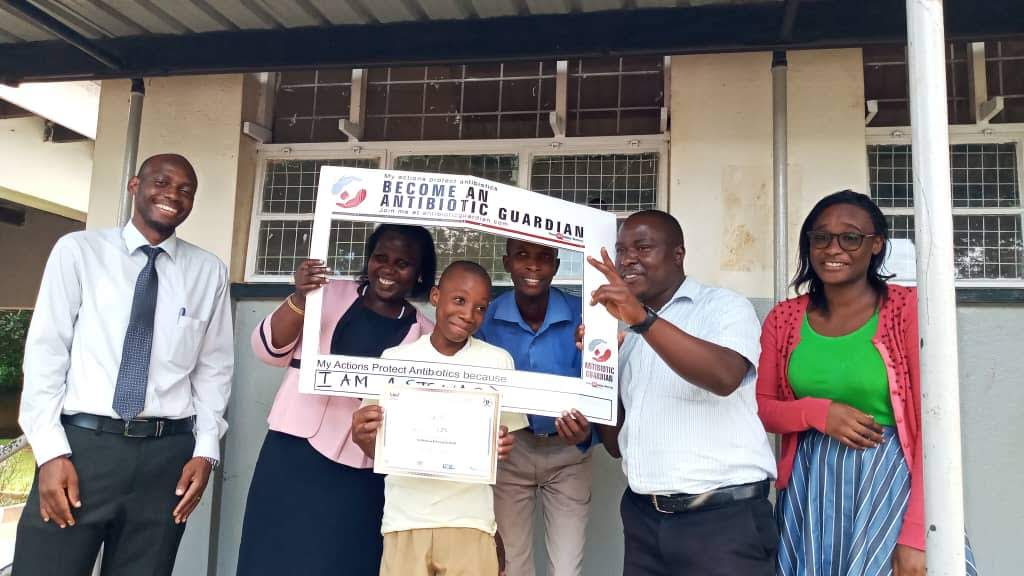 Alvin with his certificate is joined by the headmistress and other teachers at St. Theresas Primary School to celebrate his achievement. Far left is Grace Biyinzika Lubega, the project coordinator